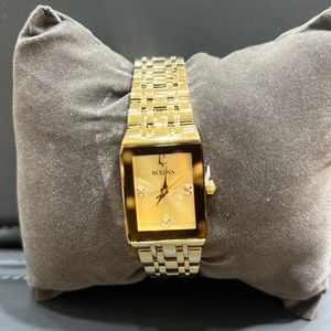 Brand New lady Bulova watch gold color with diamonds.